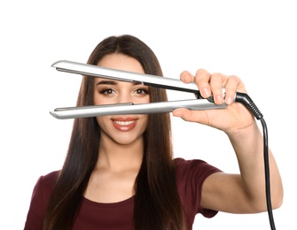 Photo of Happy woman with hair iron on white background