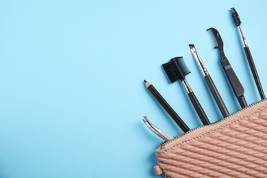 Photo of Set of professional eyebrow tools on blue background, flat lay. Space for text