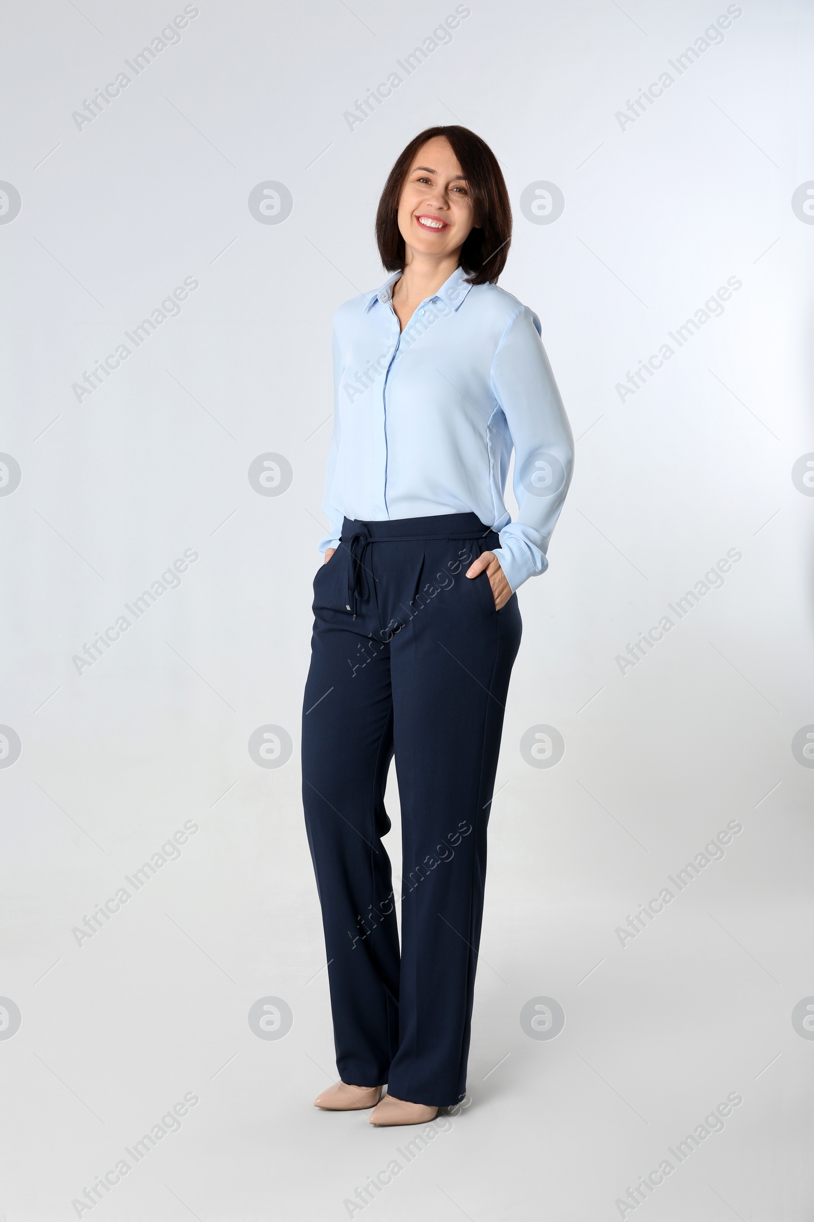 Photo of Full length portrait of mature businesswoman on white background