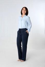 Photo of Full length portrait of mature businesswoman on white background