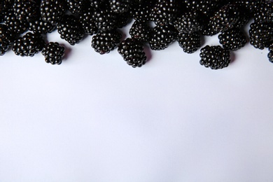 Composition with ripe blackberries on white background, top view