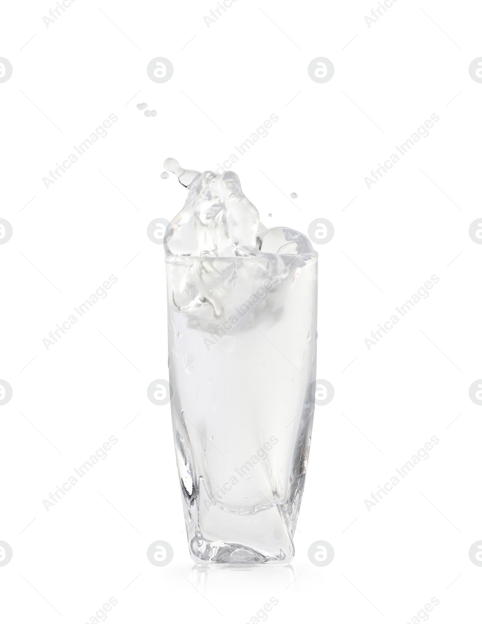 Photo of Shot of vodka with ice and splash isolated on white