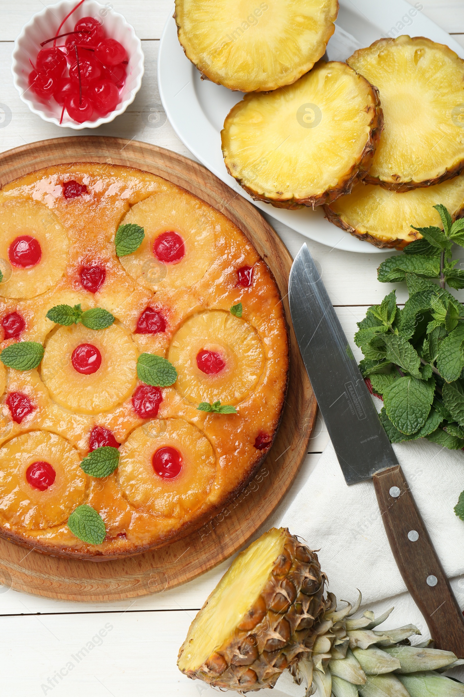 Photo of Delicious pineapple pie with cherry and mint on white wooden table, flat lay