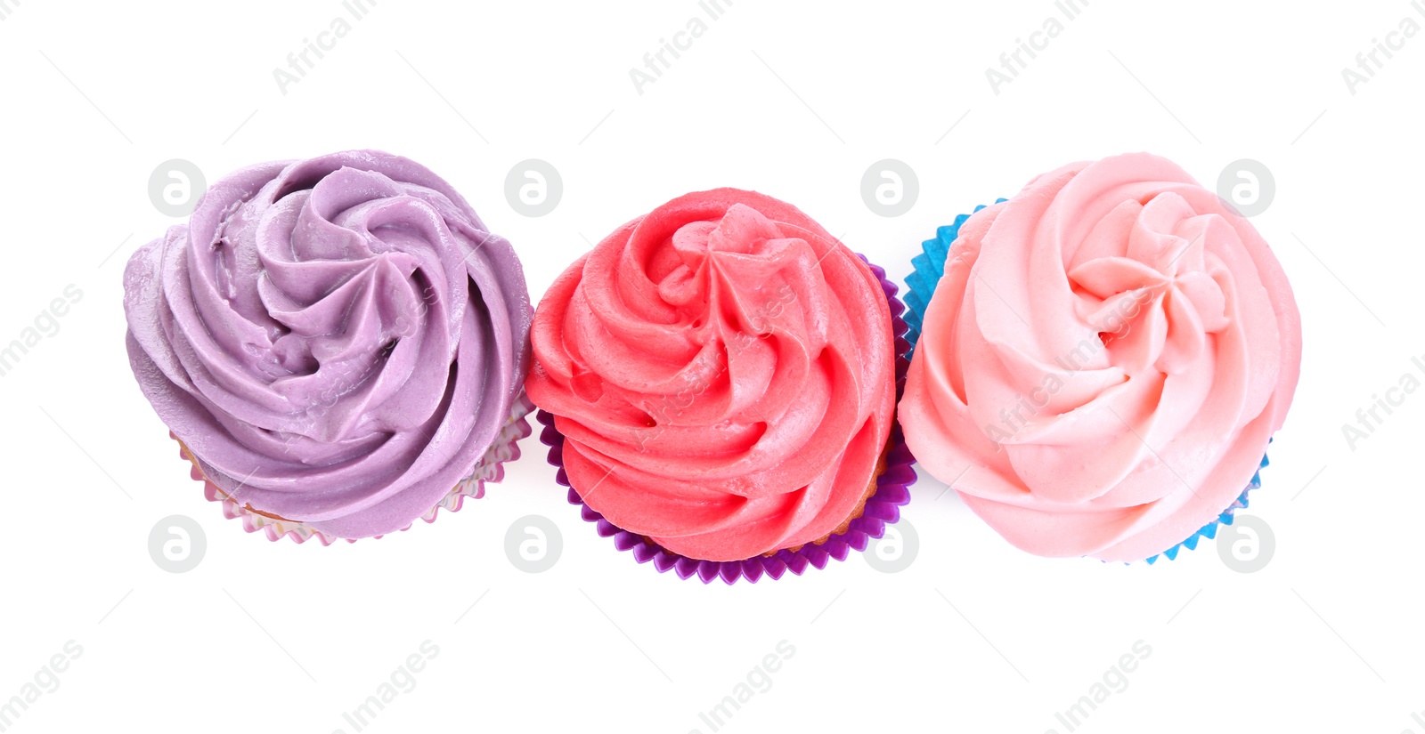 Photo of Different tasty cupcakes with cream isolated on white, top view