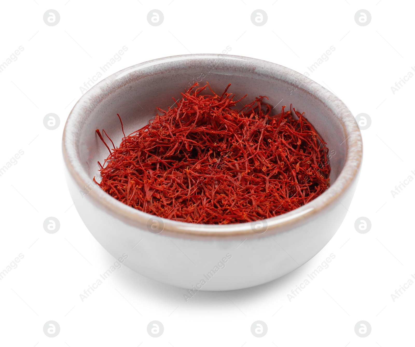 Photo of Aromatic saffron in bowl isolated on white