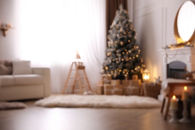 Photo of Blurred view of beautiful room interior with Christmas tree
