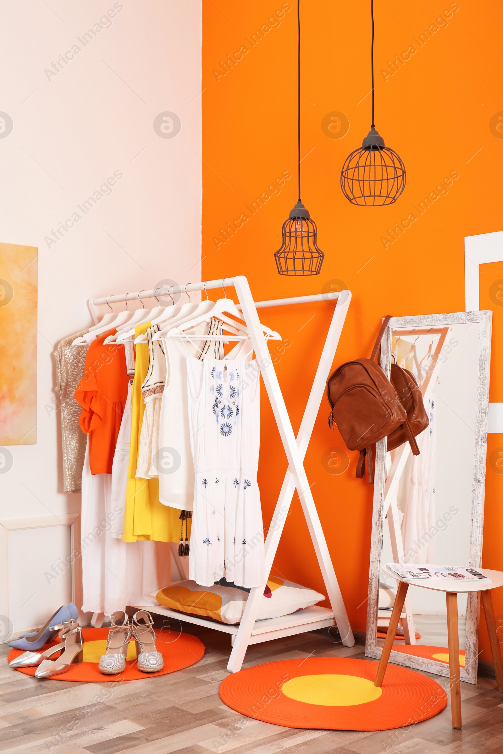 Photo of Stylish dressing room interior with clothes rack