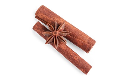 Photo of Cinnamon sticks and anise star isolated on white, top view