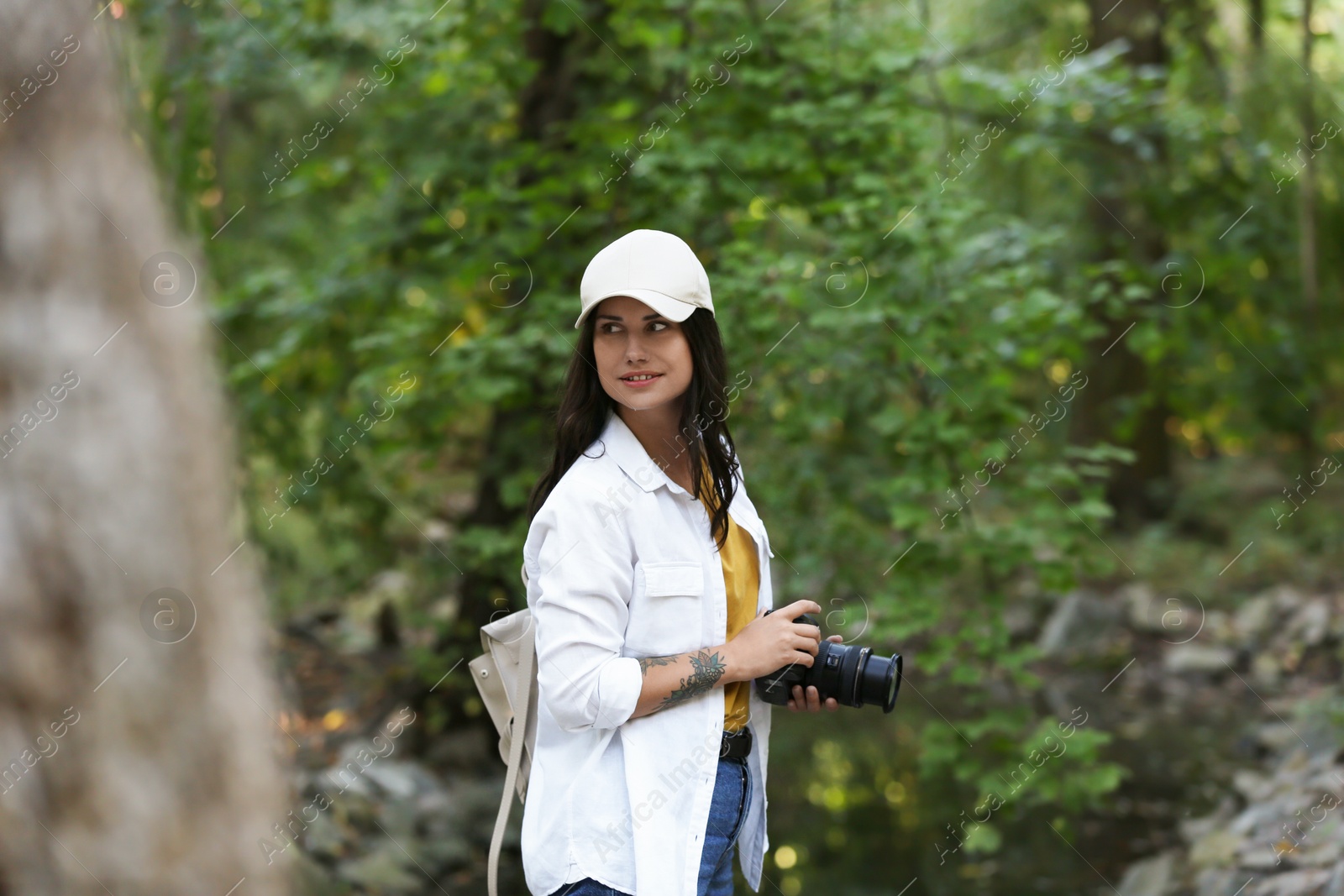 Photo of Beautiful woman with camera spending time in nature reserve