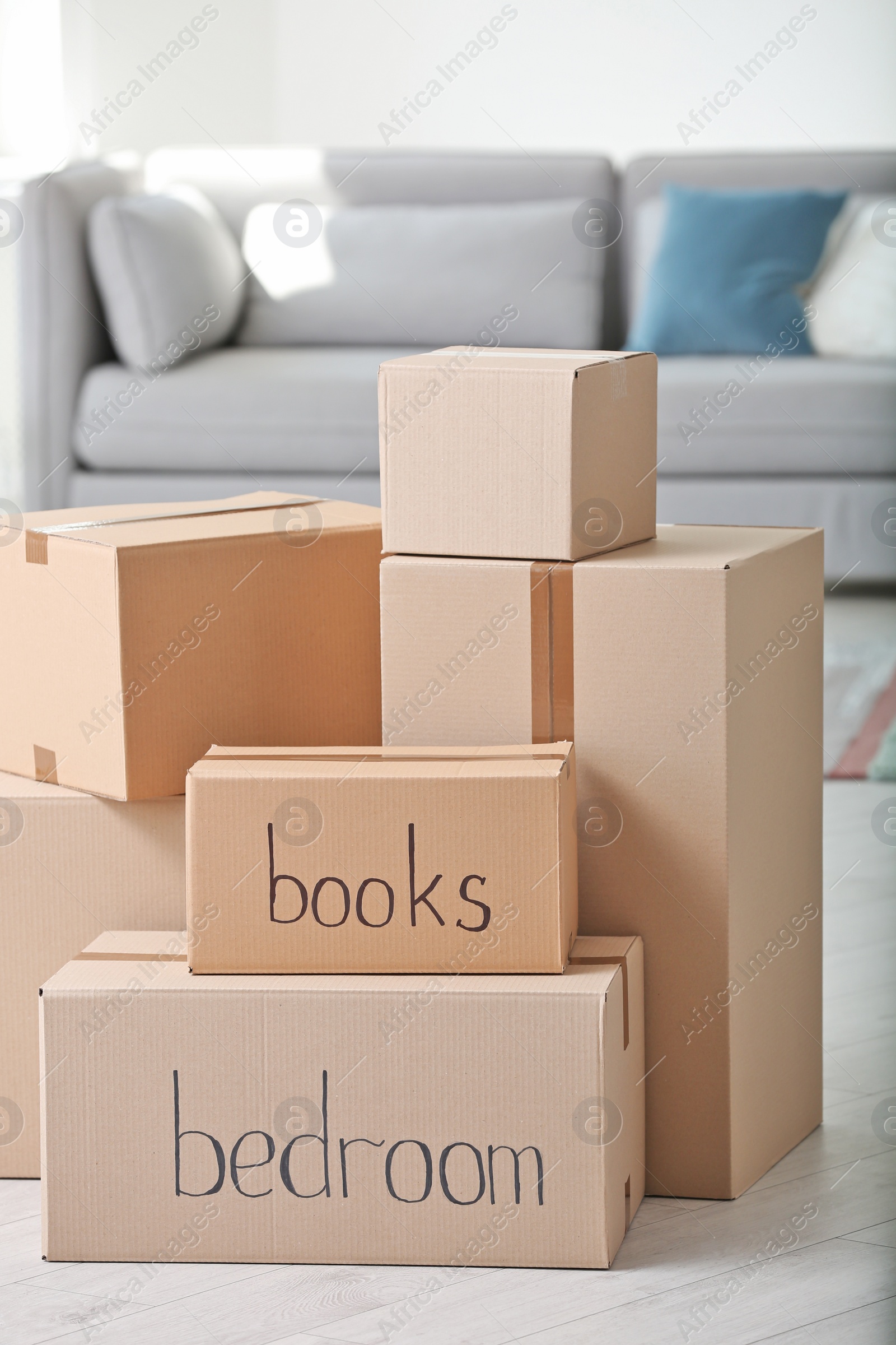 Photo of Pile of moving boxes in living room