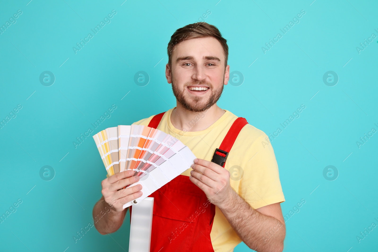 Photo of Male decorator with palette on color background