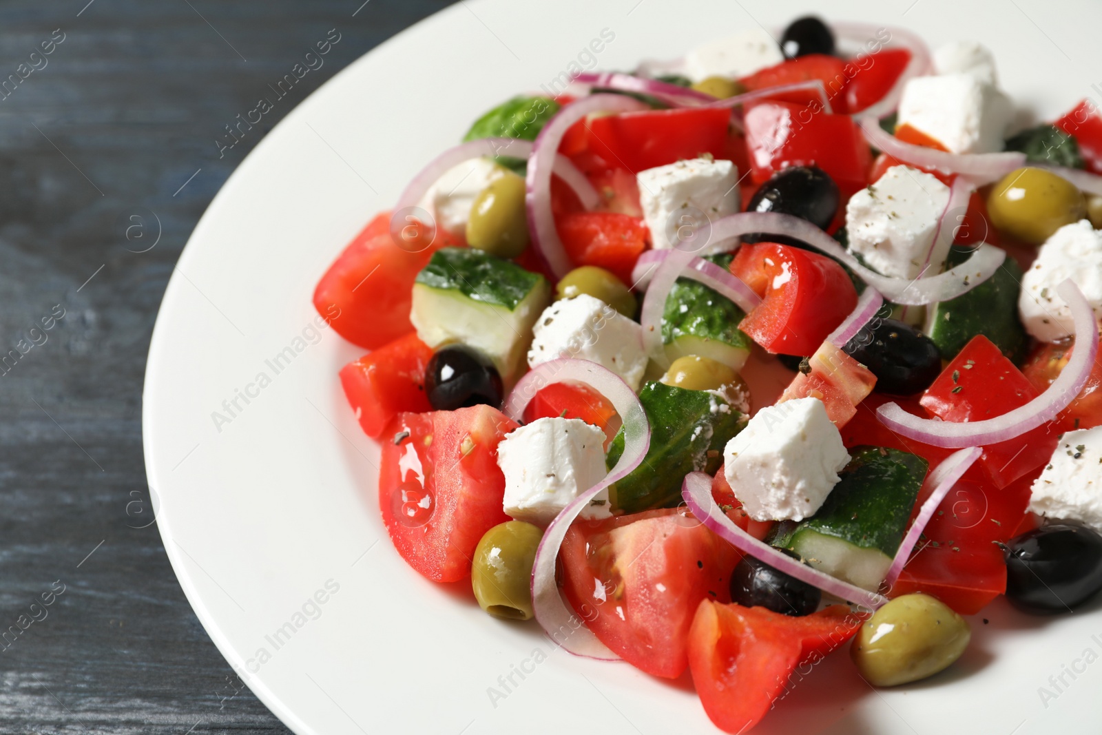 Photo of Plate with delicious salad on table, closeup