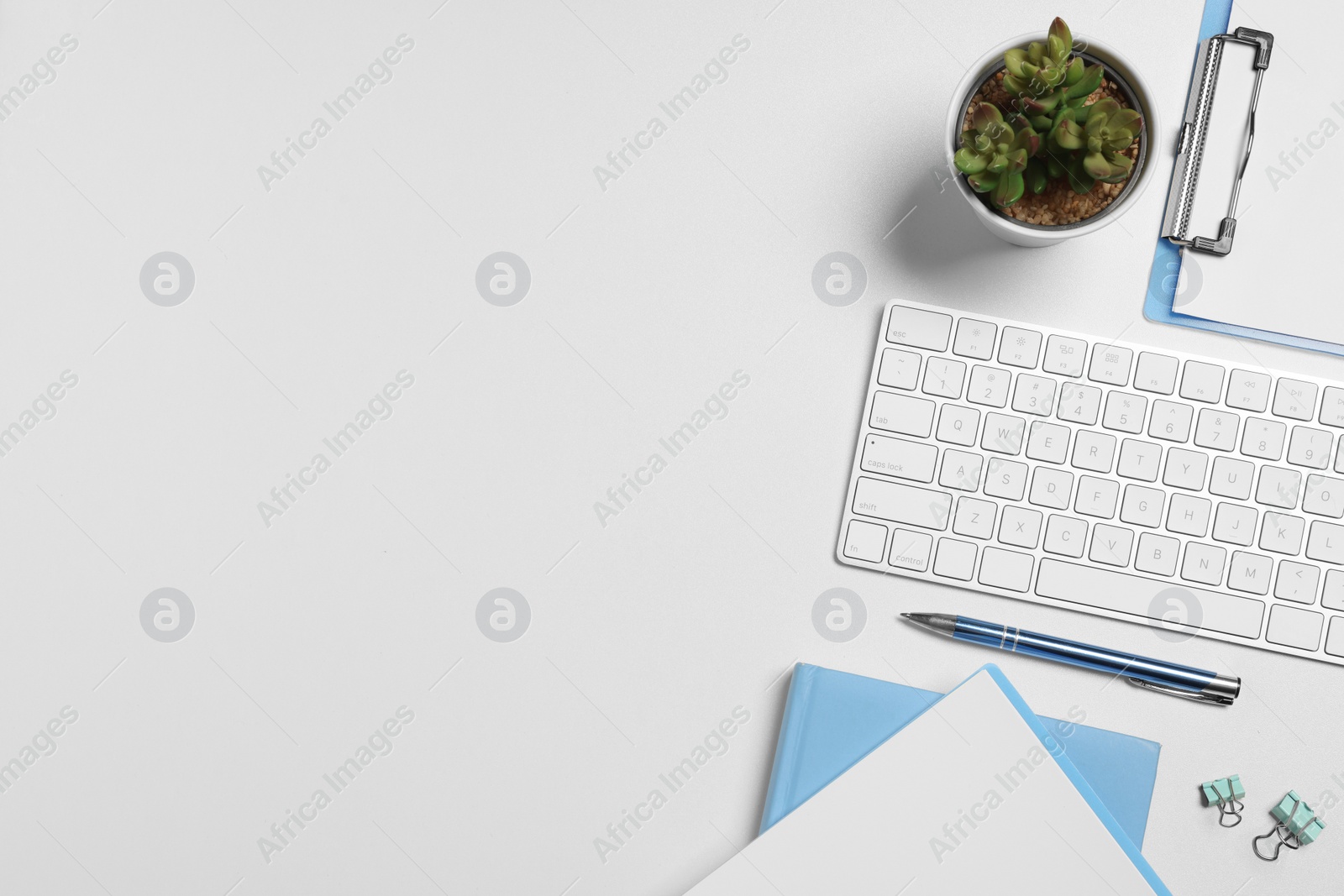 Photo of Flat lay composition with keyboard and office stationery on beige desk, space for text. Work from home