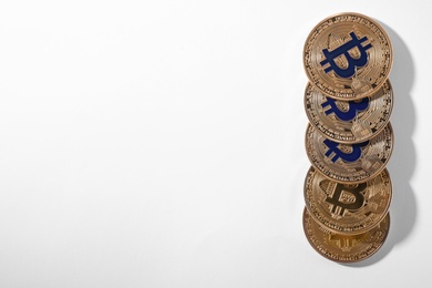 Golden bitcoins on white background, top view. Digital currency