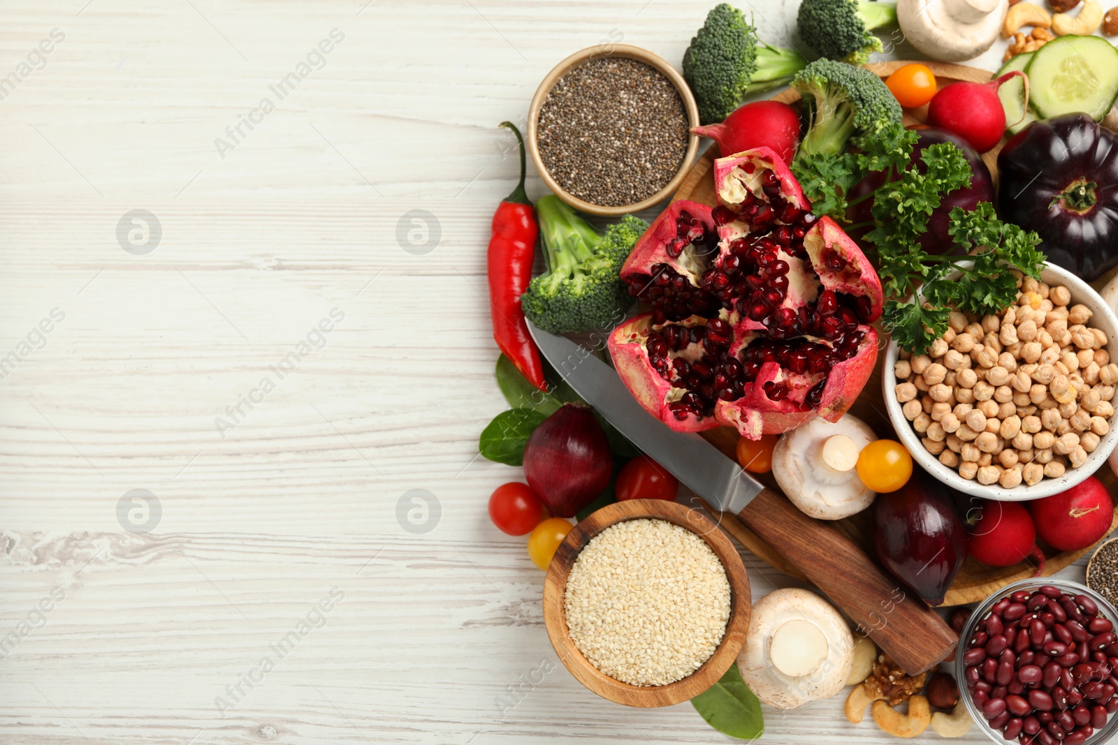 Photo of Different vegetables on white wooden table, flat lay and space for text. Vegan diet