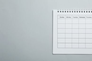 Blank calendar on light grey background, top view. Space for text