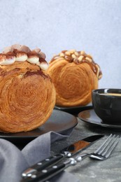 Photo of Crunchy round croissants served on grey table. Tasty puff pastry