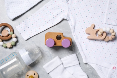 Photo of Flat lay composition with cute baby items on grey background