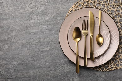 Photo of Stylish table setting with cutlery on grey surface, top view and space for text