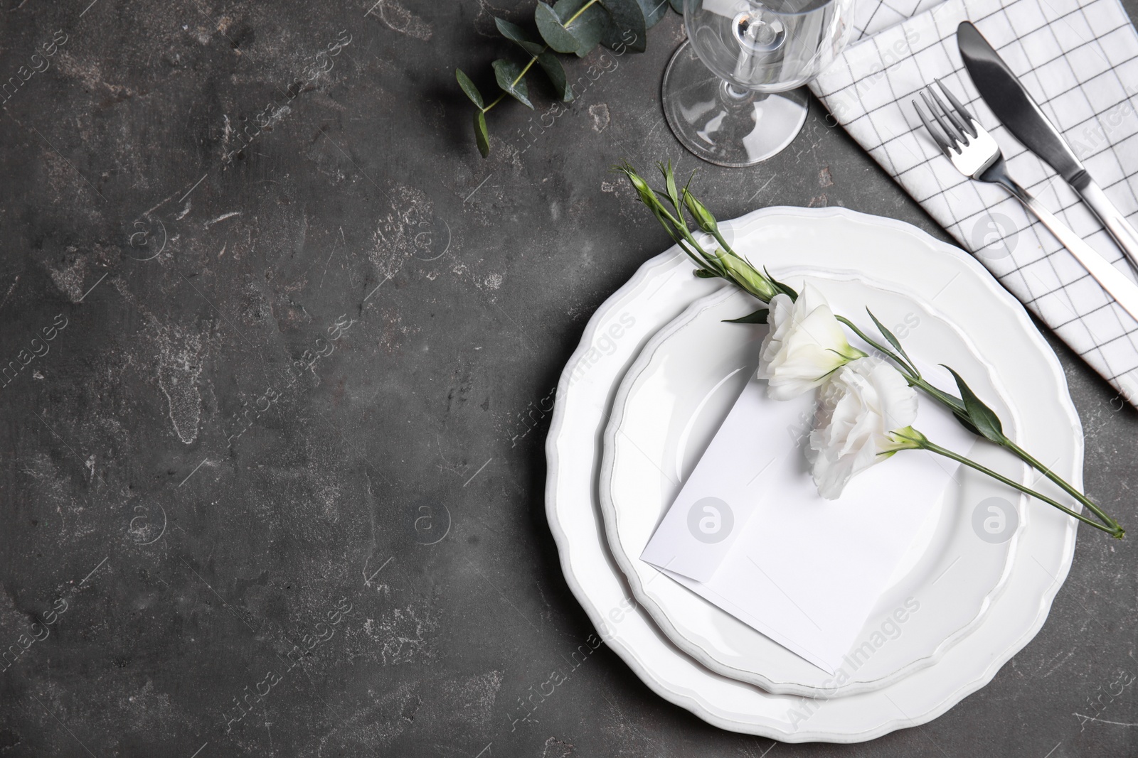 Photo of Elegant festive table setting on dark grey background, flat lay. Space for text