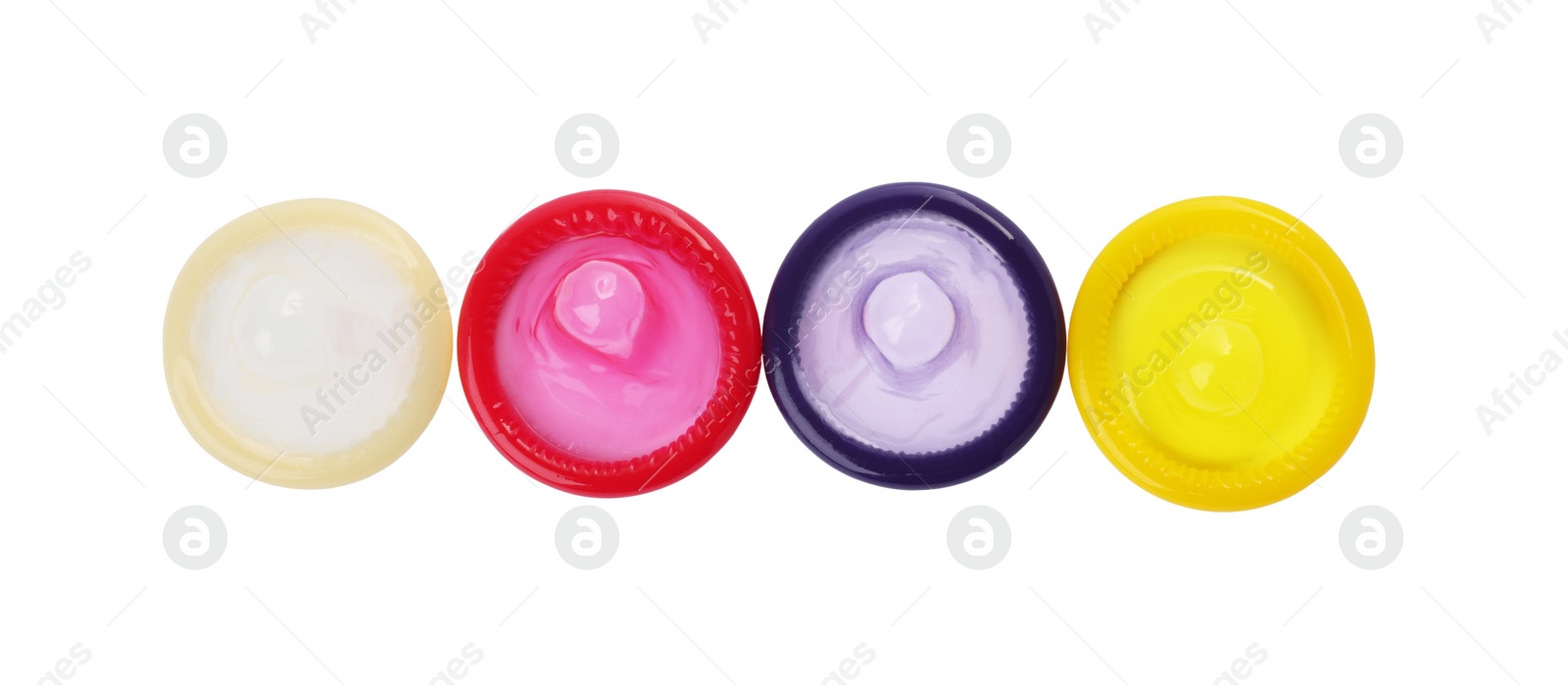 Photo of Unpacked condoms on white background, top view. Safe sex