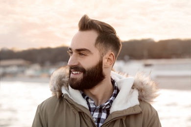 Portrait of stylish young man near sea