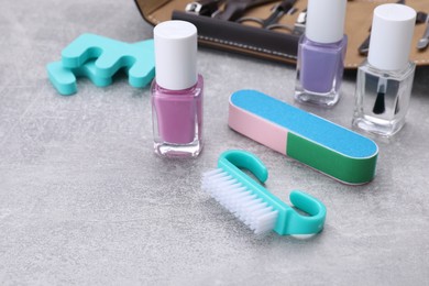 Set of pedicure tools on light gray background