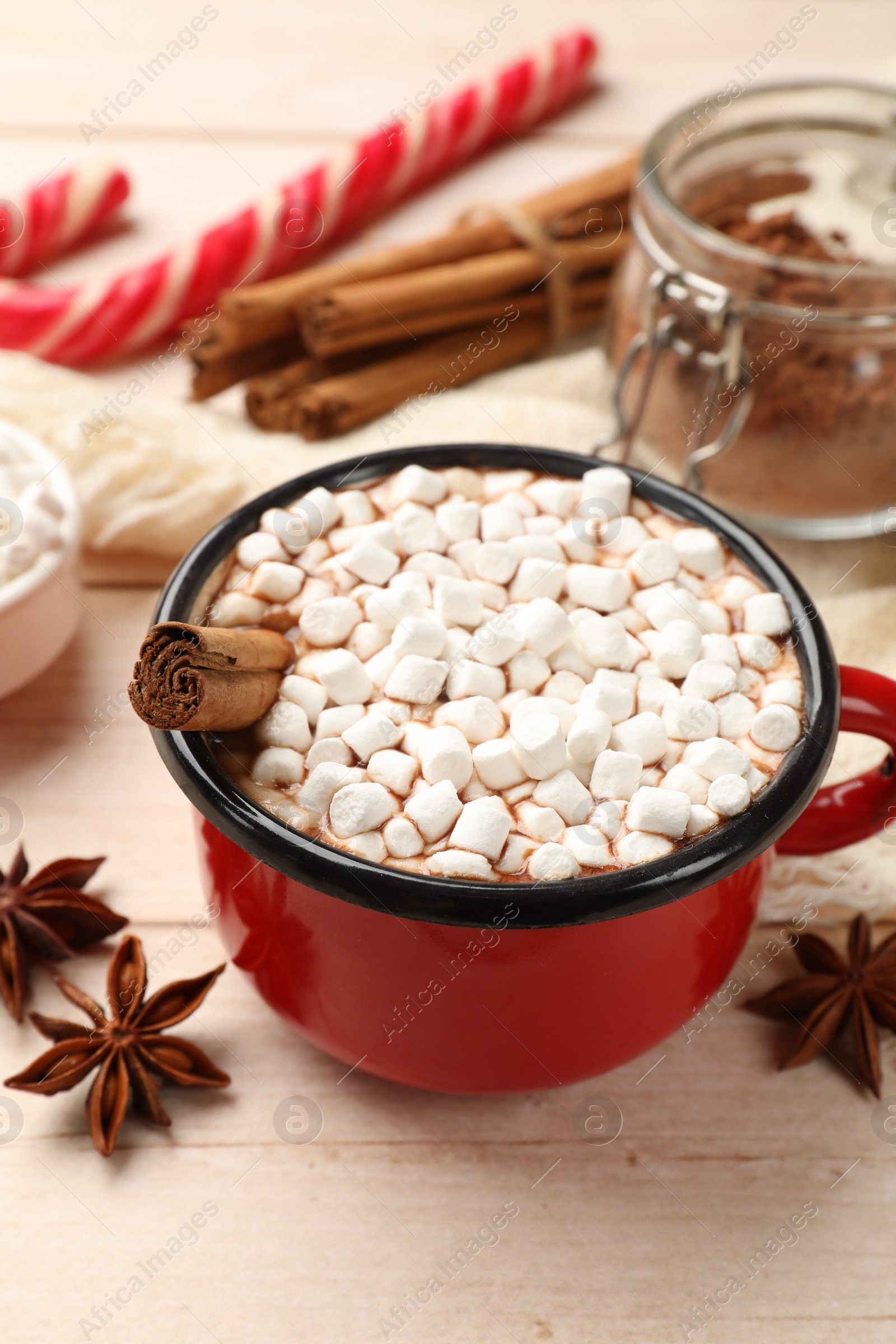 Photo of Tasty hot chocolate with marshmallows on white wooden table, closeup