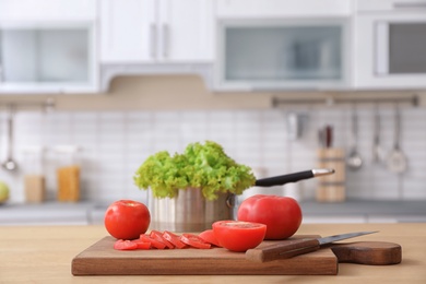 Fresh vegetables and blurred view of kitchen interior on background