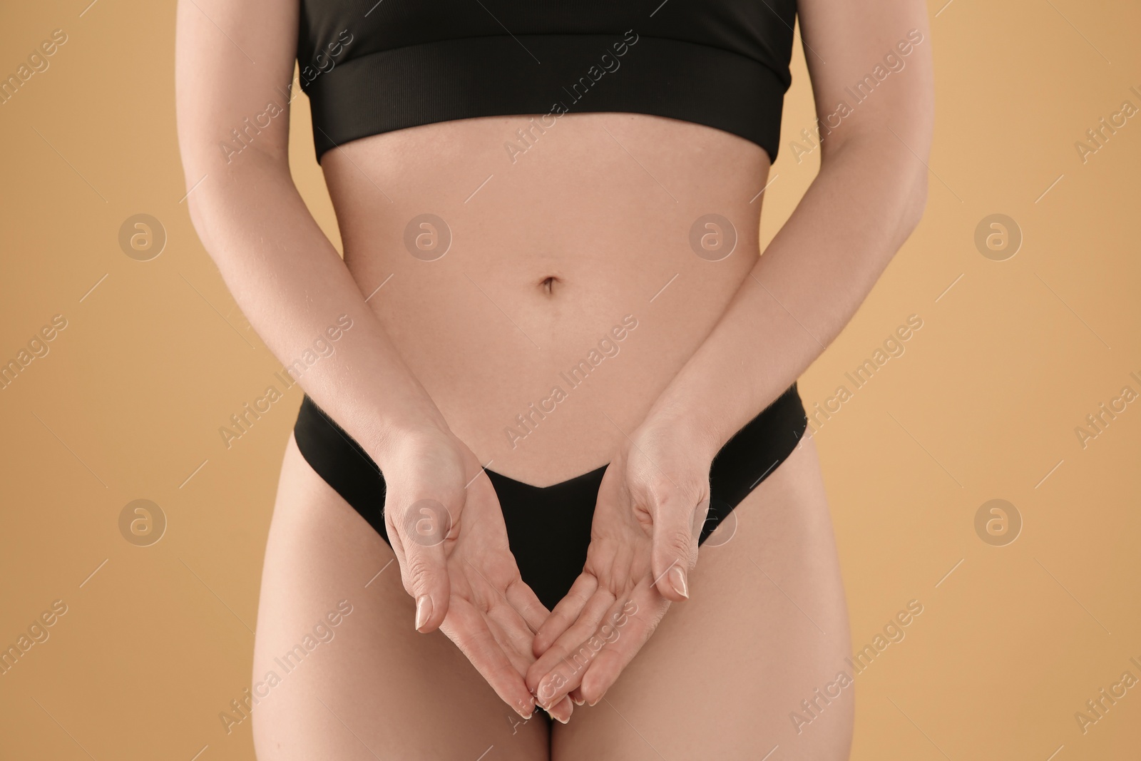 Photo of Gynecology. Woman in underwear on yellow background, closeup