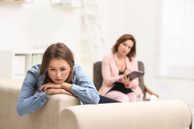 Psychotherapist working with teenage girl in office