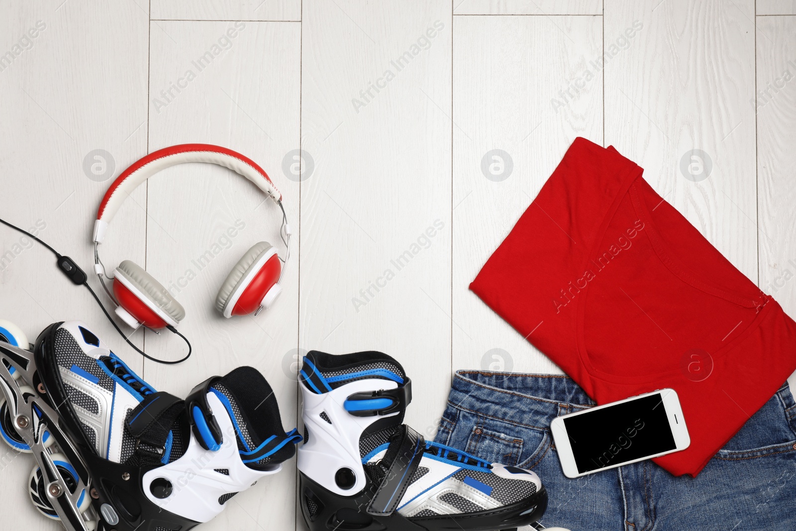 Photo of Flat lay composition with inline roller skates and space for text on wooden background