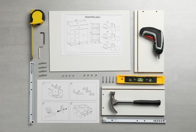 Photo of Flat lay composition with furniture parts and tools for self-assembly on light grey background