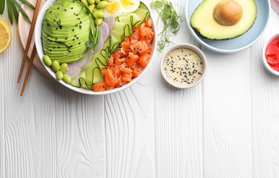 Photo of Delicious poke bowl with avocado, fish and edamame beans on white wooden table, flat lay. Space for text