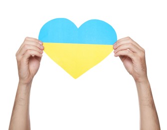 Photo of Man holding paper heart in colors of Ukrainian flag on white background, closeup