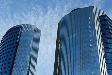 Exterior of beautiful skyscrapers against blue sky, low angle view