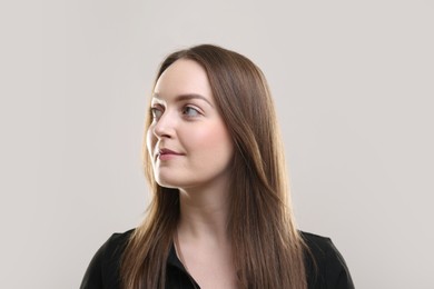 Photo of Portrait of beautiful young woman on beige background