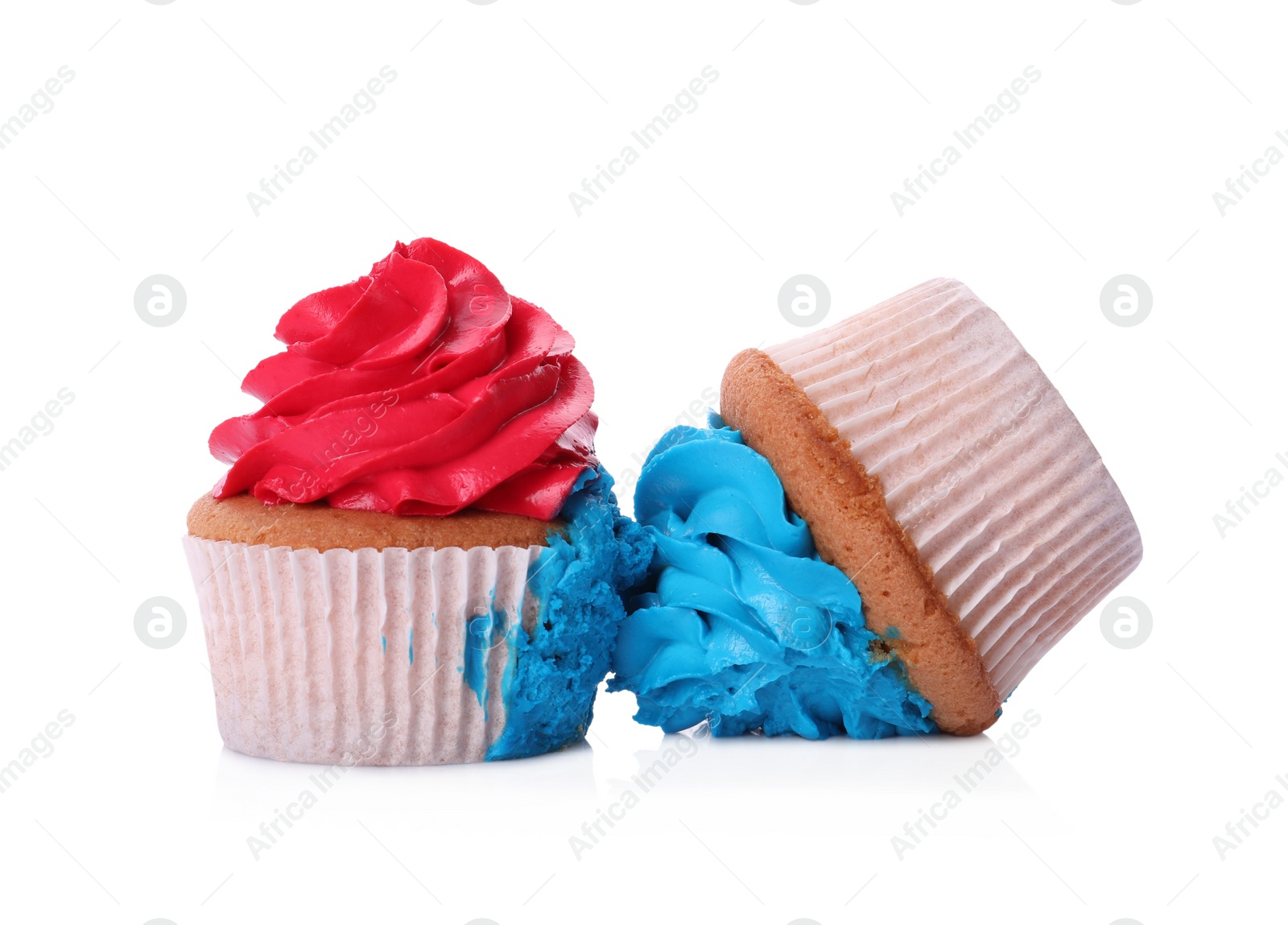 Photo of Two failed cupcakes with cream on white background. Troubles happen