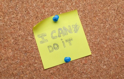 Photo of Motivation concept. Changing phrase from I Can't Do It into I Can Do It by crossing out letter T on cork board