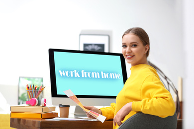 Woman near computer with text WORK FROM HOME on screen indoors