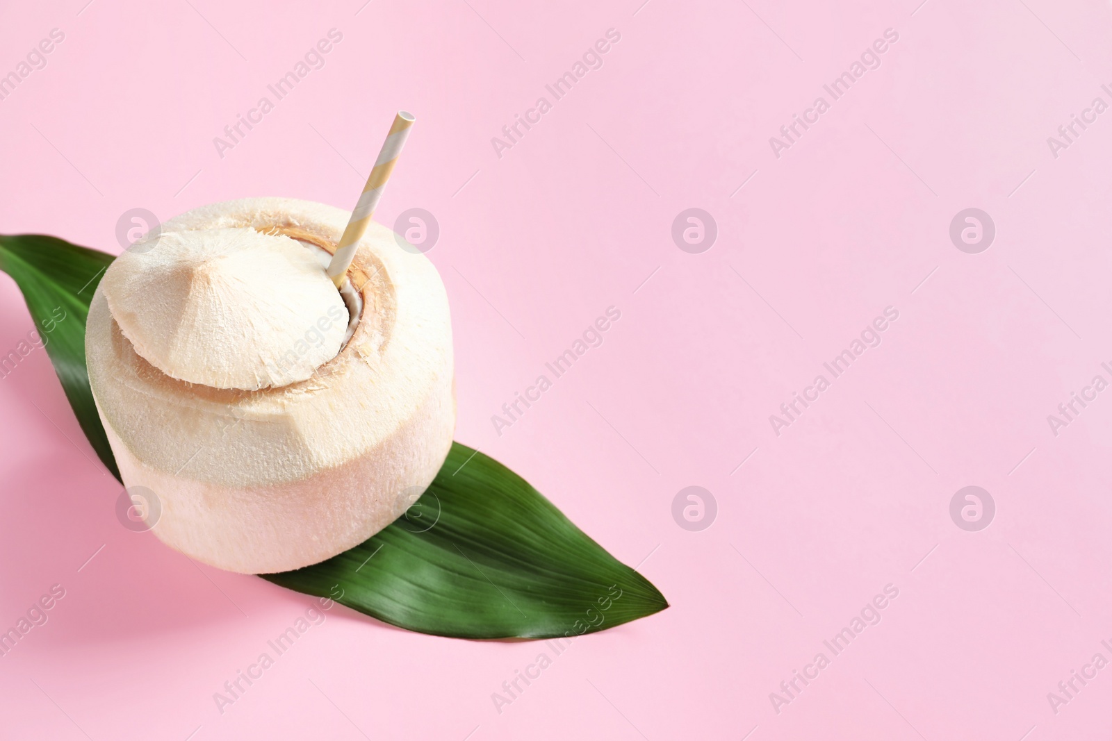 Photo of Fresh coconut drink in nut on color background