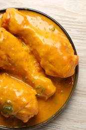 Photo of Tasty chicken curry on wooden table, top view