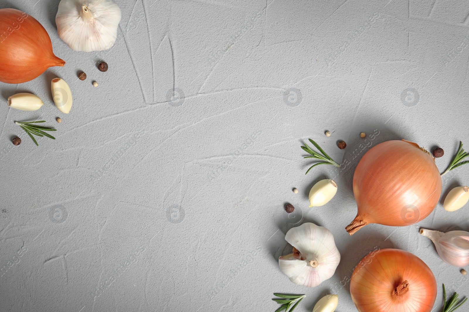 Photo of Flat lay composition with garlic, onion and space for text on table