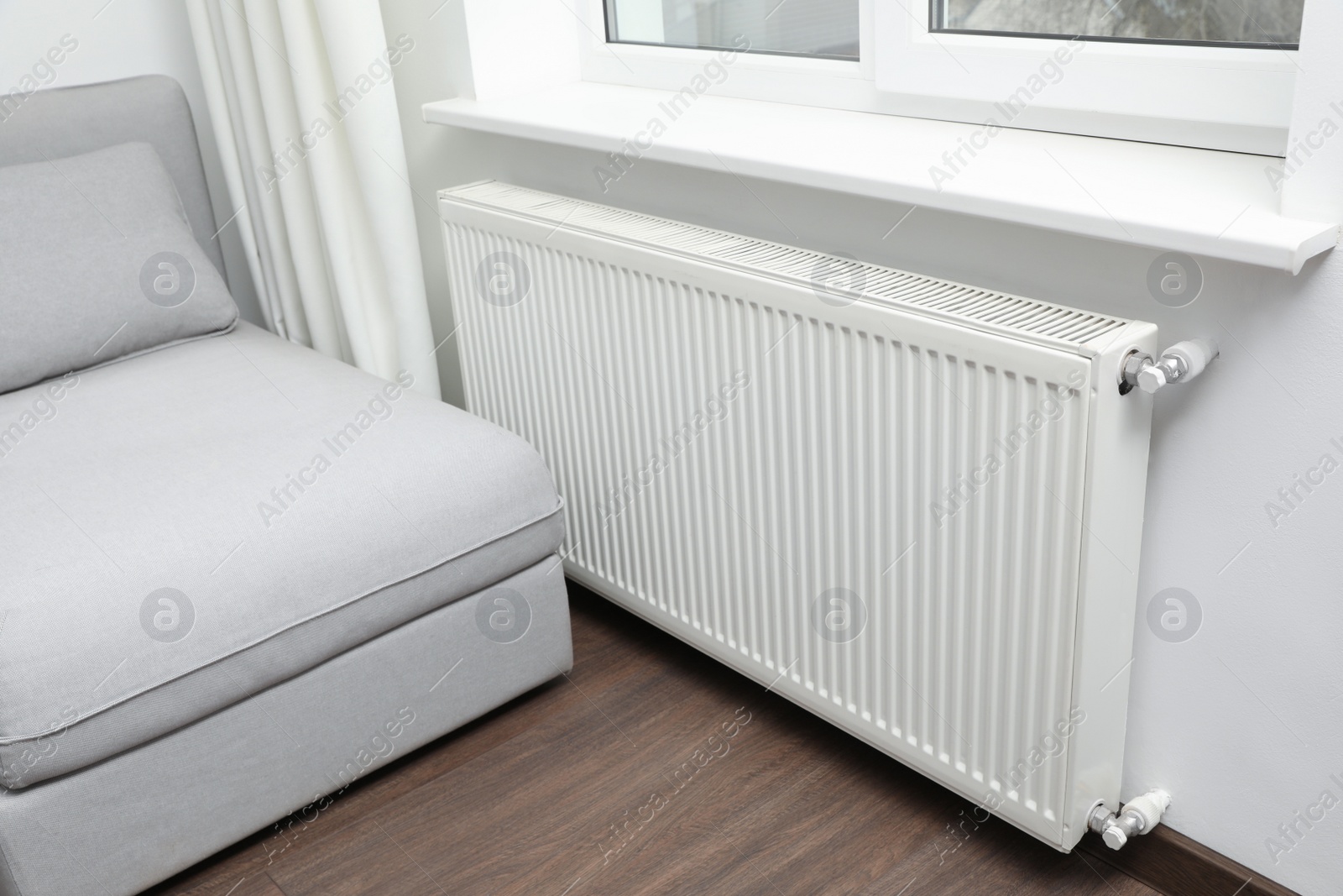 Photo of Modern radiator at home. Central heating system