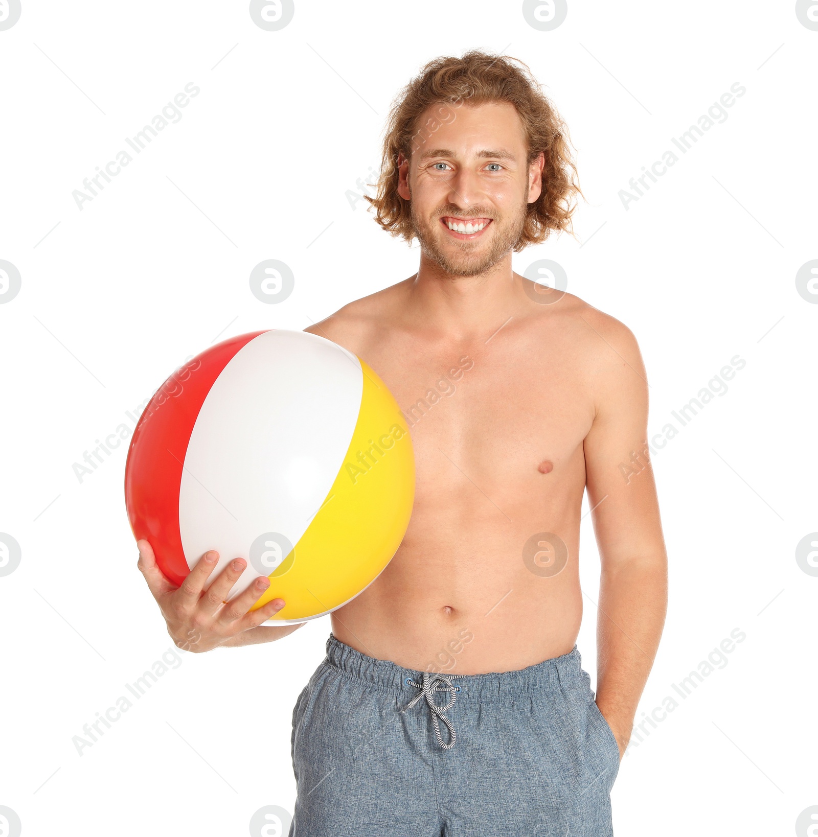 Photo of Attractive young man in beachwear with colorful inflatable ball on white background