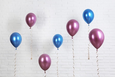 Bright colorful balloons near brick wall. Party time