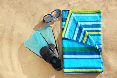 Photo of Flat lay composition of beach objects and towel on sand