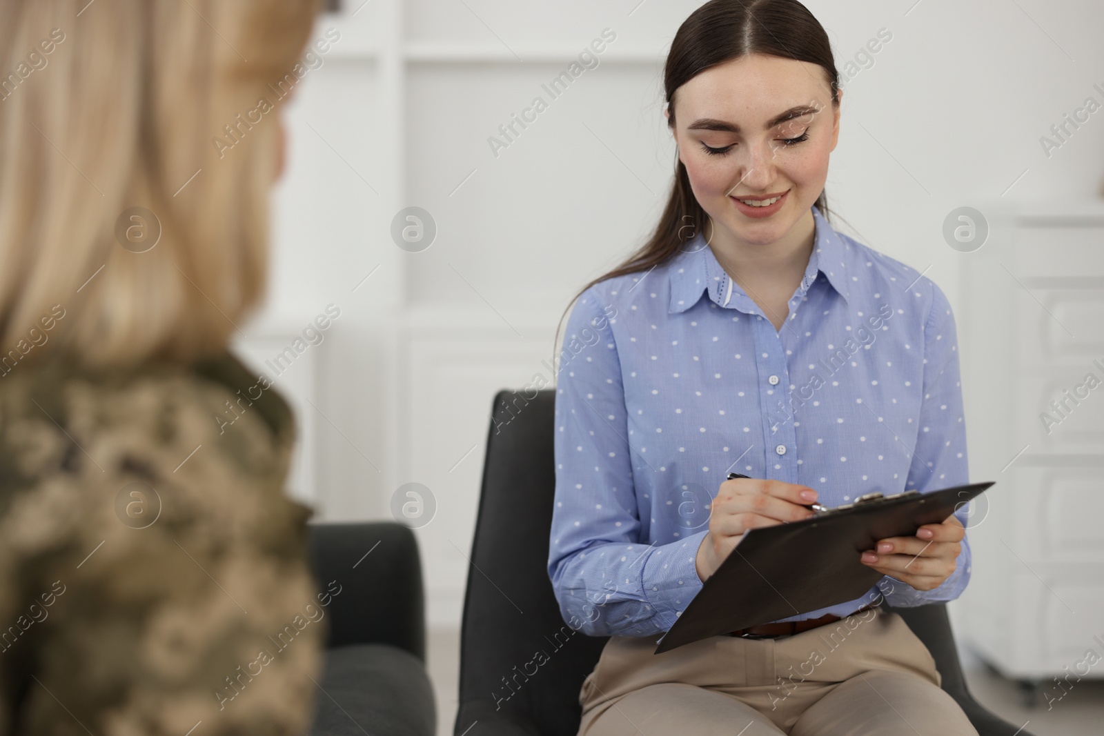 Photo of Psychotherapist working with military woman in office