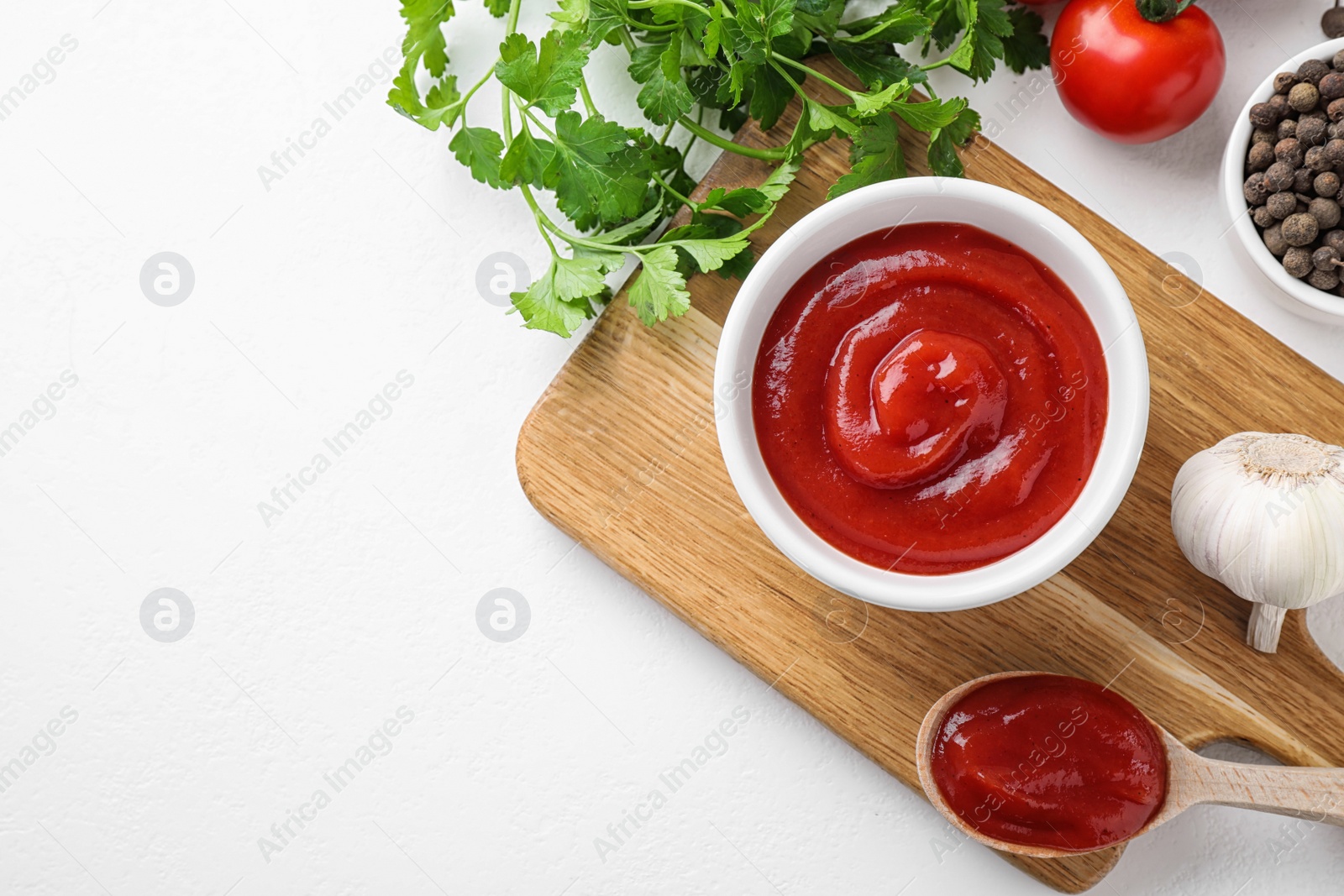 Photo of Flat lay composition with tomato sauce on white table, space for text