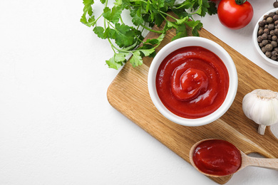 Flat lay composition with tomato sauce on white table, space for text